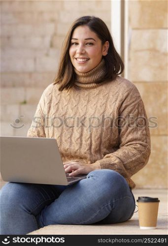 casual teenager holding her laptop