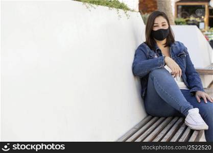 casual teenager wearing face mask outdoors