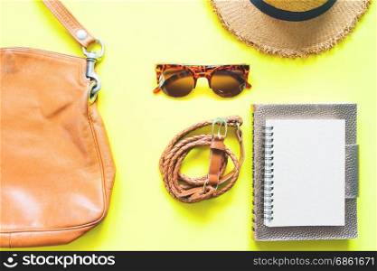 Casual woman clothing and accessories in brown concept on yellow background