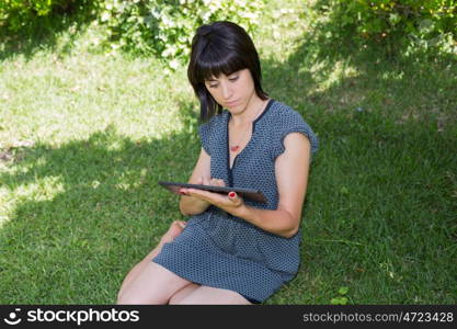 casual woman working with a tablet pc, outdoor