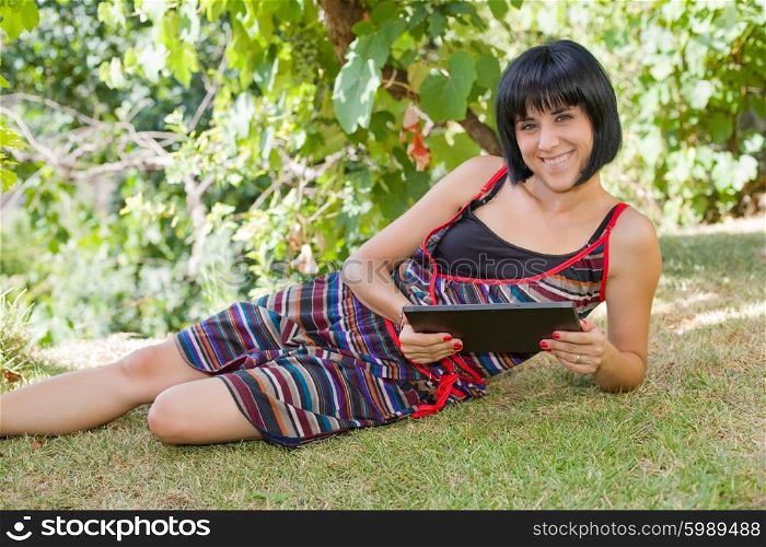 casual woman working with a tablet pc, outdoor