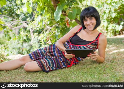 casual woman working with a tablet pc, outdoor