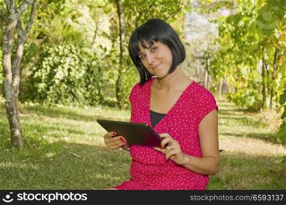 casual woman working with a tablet pc, outdoor
