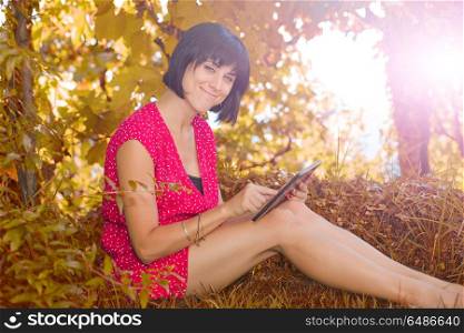 casual woman working with a tablet pc, outdoor. woman with tablet