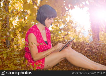 casual woman working with a tablet pc, outdoor. woman with tablet