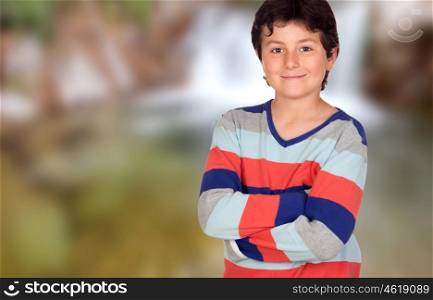 Casual young boy with arms crossed on a unfocused background