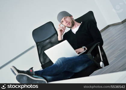 casual young business man relax and work on laptop computer with foots on table