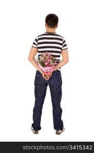 Casual young man standing back to the camera hiding bouquet of flowers behind his back, isolated on white background