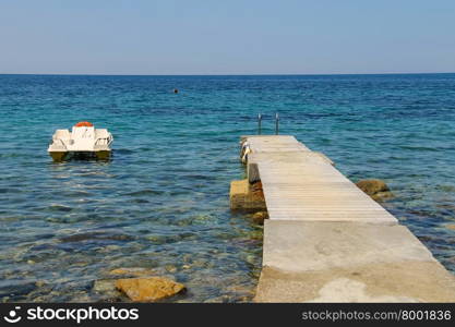 Catamaran near the pier on the coast of the Tyrrhenian Sea, Elba Island, Tuscany, Italy