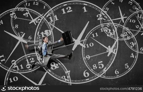 Catch up with time. Concept of time with funny businessman running in a hurry