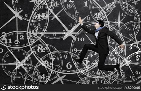 Catch up with time. Concept of time with funny businessman running in a hurry