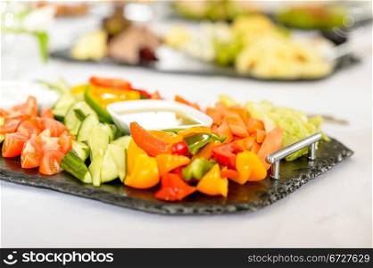 Catering table buffet full of tasty food vegetable salad plate