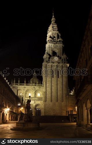 Cathedral of Santiago of Compostela seen from Silversmith Square at night. Plaza de Platerias with Cathedral Clock Tower and Fountain of the Horses view