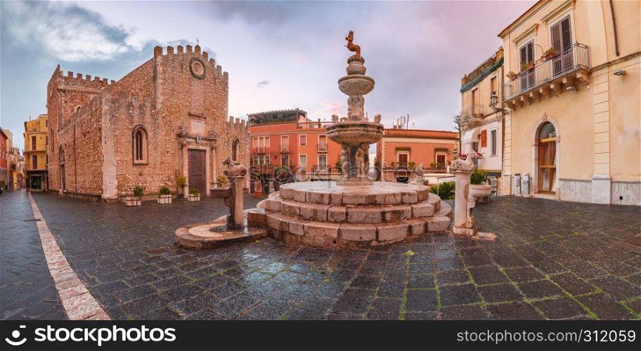 Cathedral of Taormina and fountain on the square Piazza Duomo in Taormina at rainy night, Sicily, Italy. Piazza Duomo in Taormina, Sicily, Italy