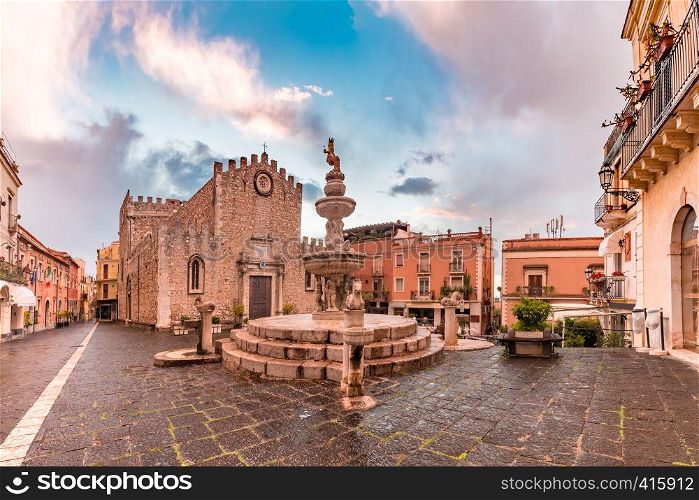 Cathedral of Taormina and fountain on the square Piazza Duomo in Taormina at rainy night, Sicily, Italy. Piazza Duomo in Taormina, Sicily, Italy