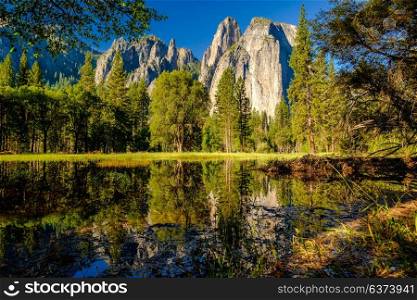 Cathedral Rocks reflecting in Merced River at Yosemite National Park. California, USA.