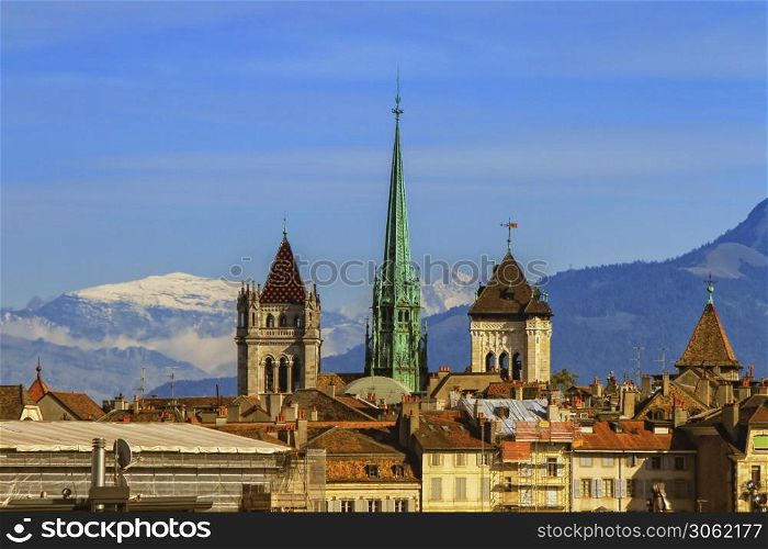 Cathedral Saint-Pierre towers and Alps mountains by day, Geneva, Switzerland. Cathedral Saint-Pierre towers and Alps mountains, Geneva, Switzerland