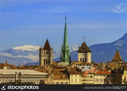 Cathedral Saint-Pierre towers and Alps mountains by day, Geneva, Switzerland. Cathedral Saint-Pierre towers and Alps mountains, Geneva, Switzerland