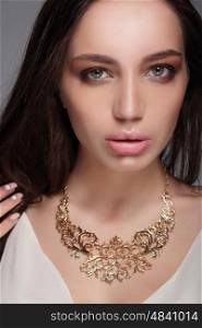 Caucasian attractive sexy fashion model with long brunette natural hair, beautiful eyes, full lips, perfect skin. Decoration of around his neck.