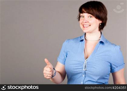 caucasian business woman is holding blank space on gray background