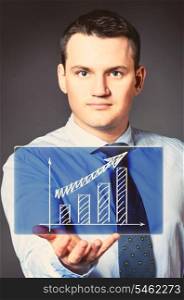 caucasian businessman is holding a bar chart in hands. business man with icon
