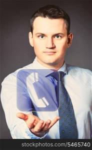 caucasian businessman is holding phone icon in hands. business man with icon