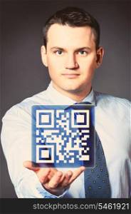 caucasian businessman is holding qr code in hands. business man with icon