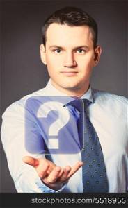 caucasian businessman is holding question in hands