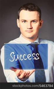 caucasian businessman is holding success text in hands. business man with icon