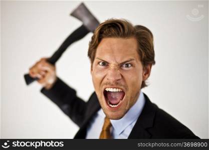 Caucasian businessman with a axe cutting costs or giving someone the axe.