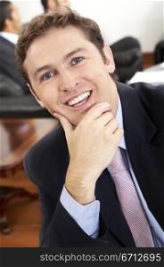 caucasian confident business man portrait in an office smiling