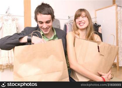 Caucasian Couple Laughing About Their Purchases At A Trendy Boutique
