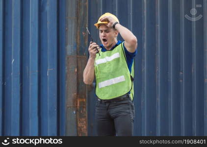 Caucasian Engineering manager complain through walkie talkie about the damage of goods while shipping. Industry Concept.