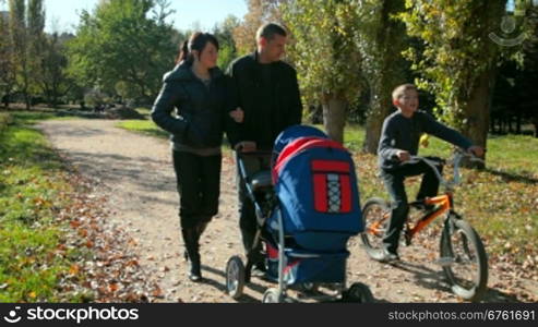 Caucasian family walking in autumn park