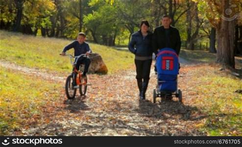 Caucasian family walking in autumn park