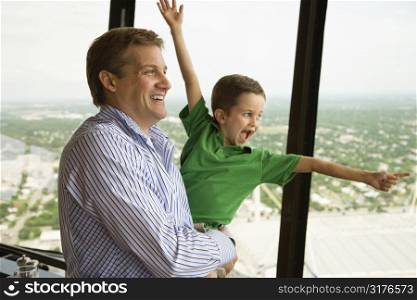 Caucasian father and son at observation deck at Tower of the Americas in San Antonio, Texas.
