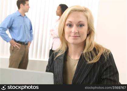 Caucasian Female Business Professional Sitting Behind A Laptop Computer