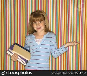 Caucasian female child holding books.