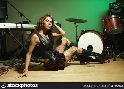 Caucasian female posing with musical equipment.