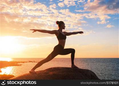 caucasian fitness woman practicing yoga. caucasian fitness woman practicing yoga at sunset