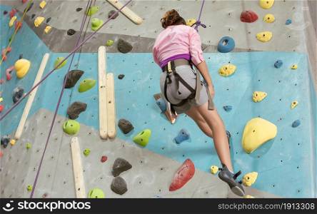 Caucasian girl playing and climbing rock mountain for adventure and sport. Activity and Education Concept.