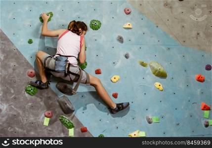 Caucasian girl playing and climbing rock mountain for adventure and sport. Activity and Education Concept.