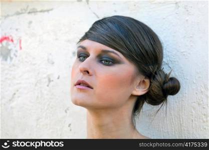 Caucasian girl portrait with makeup on white wall background