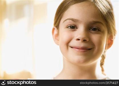 Caucasian girl smiling at viewer.