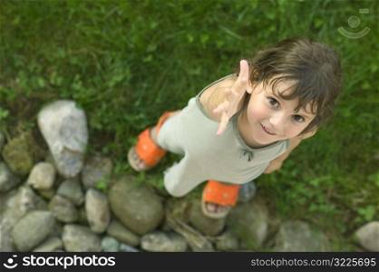 Caucasian Girl Standing On Rocks And Grass And Reaching For Your Hand