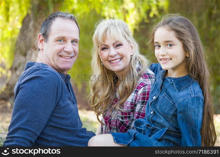 Caucasian Grandmother and Grandfather With Young Mixed Race Grandaughter Outdoors.