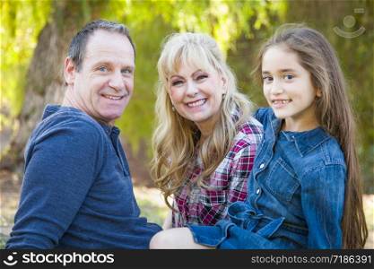 Caucasian Grandmother and Grandfather With Young Mixed Race Grandaughter Outdoors.