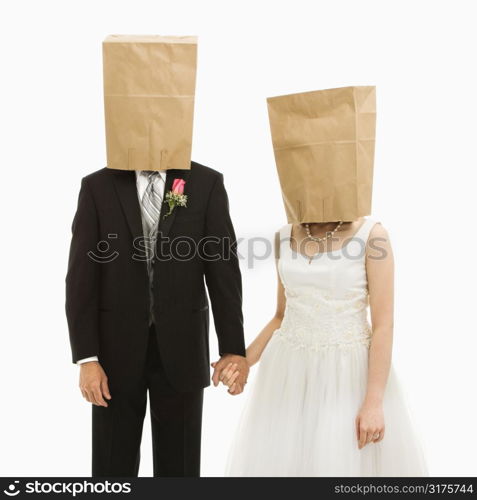 Caucasian groom and Asian bride with brown paper bags over their heads.
