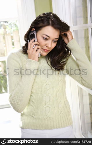 Caucasian/Hispanic young woman on cell phone.