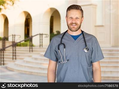 Caucasian Male Nurse In Front Of Hospital Building.